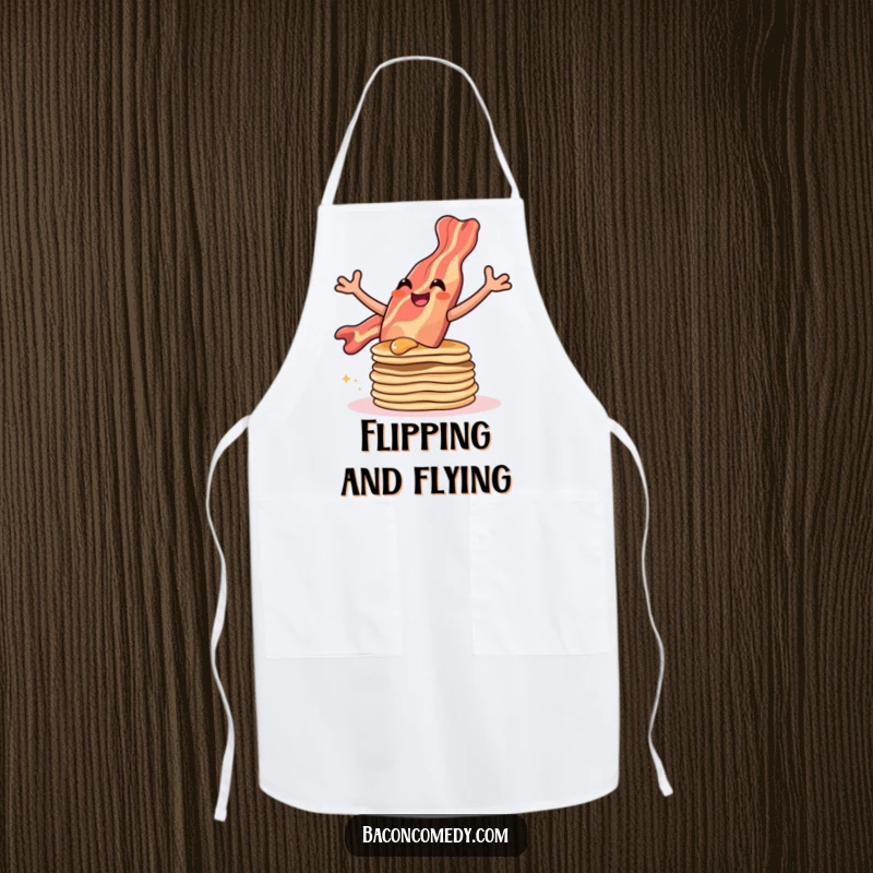 Funny apron depicting a bacon strip leaping gleefully over a stack of pancakes, perfect for a joyful cooking experience.
